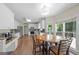 Bright eat-in kitchen with wooden floors, wooden kitchen table, and white cabinets at 1130 S Rudder Rd, Cumming, GA 30041