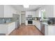 Well-lit kitchen featuring stainless steel appliances, granite countertops, and white cabinets at 1130 S Rudder Rd, Cumming, GA 30041