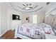 Comfortable main bedroom featuring decorative tray ceiling, quilt, and hardwood floors at 1130 S Rudder Rd, Cumming, GA 30041