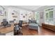 A beautiful office space with hardwood floors, a chair, a desk, and extensive shelving at 1130 S Rudder Rd, Cumming, GA 30041