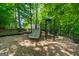Neighborhood playground features a slide and climbing structure in a wooded area, perfect for play at 1130 S Rudder Rd, Cumming, GA 30041
