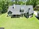 The backyard features a covered porch, well-maintained lawn, and a detached garage at 120 Laurel Forest Dr, Tyrone, GA 30290
