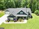 Stunning aerial view of a home with a large driveway and beautifully landscaped front yard at 120 Laurel Forest Dr, Tyrone, GA 30290