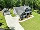 Aerial shot shows the house, detached garage, long driveway, and landscaped yard at 120 Laurel Forest Dr, Tyrone, GA 30290