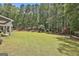 Spacious backyard featuring a lush lawn and natural border provided by tall trees at 120 Laurel Forest Dr, Tyrone, GA 30290