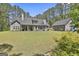 Lush green backyard with a detached garage and beautiful landscaping around the house at 120 Laurel Forest Dr, Tyrone, GA 30290