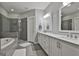 Modern bathroom with glass-enclosed shower, soaking tub, double vanity, and elegant fixtures at 120 Laurel Forest Dr, Tyrone, GA 30290