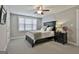 Comfortable bedroom with carpet flooring, ceiling fan and natural light through the window overlooking the backyard at 120 Laurel Forest Dr, Tyrone, GA 30290