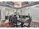 A dining room shows the details of the chairs, table, and lighting, and hardwood floors at 120 Laurel Forest Dr, Tyrone, GA 30290