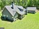 Gray home featuring an inviting, covered back porch and a separate garage at 120 Laurel Forest Dr, Tyrone, GA 30290