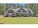 Charming gray home featuring a well-manicured lawn and complementing exterior landscaping at 120 Laurel Forest Dr, Tyrone, GA 30290