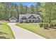 Attractive exterior view of home with attached garage and long private driveway at 120 Laurel Forest Dr, Tyrone, GA 30290