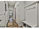 Mud room entrance with tile flooring, coat rack, storage bench and natural light through the doorway at 120 Laurel Forest Dr, Tyrone, GA 30290