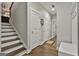 Inviting foyer with hardwood floors, staircase, coat rack and storage space for shoes and accessories at 120 Laurel Forest Dr, Tyrone, GA 30290