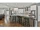 A kitchen with stainless steel appliances, white cabinetry, a breakfast bar, and a dark wood floor at 120 Laurel Forest Dr, Tyrone, GA 30290