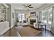 Inviting living room with stone fireplace, built-in shelves, hardwood floors, and plenty of natural light at 120 Laurel Forest Dr, Tyrone, GA 30290