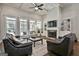 Open-concept living room boasts high ceilings, large windows, fireplace, and hardwood floors at 120 Laurel Forest Dr, Tyrone, GA 30290