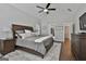 Main bedroom with vaulted ceilings, dark wood furniture and a stylish ceiling fan at 120 Laurel Forest Dr, Tyrone, GA 30290