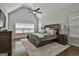 Comfortable main bedroom with vaulted ceiling, neutral decor, and large windows at 120 Laurel Forest Dr, Tyrone, GA 30290