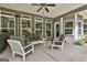 Outdoor patio area with a ceiling fan and comfortable seating, ideal for entertaining guests at 120 Laurel Forest Dr, Tyrone, GA 30290