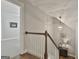 Bright staircase with white railing, wood steps, and chandelier adds charm to the entryway of the home at 120 Laurel Forest Dr, Tyrone, GA 30290