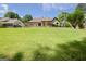 Expansive backyard with lush lawn, mature trees, spacious lawn, deck, and screened porch at 411 Baneberry Bnd, Peachtree City, GA 30269