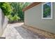 Paver patio in backyard offers outdoor entertaining space and features a garden and wooden fence at 411 Baneberry Bnd, Peachtree City, GA 30269