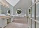 Bright bathroom with a circular window, double sink vanity, and large soaking tub at 411 Baneberry Bnd, Peachtree City, GA 30269