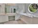 Large primary bathroom with tile floor, soaking tub, white cabinets, and vanity at 411 Baneberry Bnd, Peachtree City, GA 30269