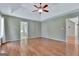 Spacious bedroom with a trey ceiling, ceiling fan, and wood floors throughout at 411 Baneberry Bnd, Peachtree City, GA 30269