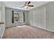 Cozy bedroom with carpet flooring, a closet, and a window providing natural light at 411 Baneberry Bnd, Peachtree City, GA 30269