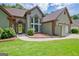 Beautiful exterior with a well-kept lawn and landscaped garden beds accenting the home's entrance at 411 Baneberry Bnd, Peachtree City, GA 30269