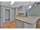 Kitchen island featuring a granite countertop and stainless steel sink, blending functionality with modern design at 411 Baneberry Bnd, Peachtree City, GA 30269