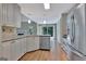 Open kitchen with stainless steel appliances, white cabinetry, and a view of the backyard through sliding glass doors at 411 Baneberry Bnd, Peachtree City, GA 30269