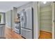 Well-maintained kitchen featuring stainless steel appliances, a pantry, and easy access to additional storage space at 411 Baneberry Bnd, Peachtree City, GA 30269