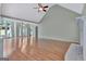 Expansive living room with hardwood floors, a vaulted ceiling, and a cozy fireplace at 411 Baneberry Bnd, Peachtree City, GA 30269