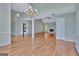 Light-filled living room with hardwood floors, elegant lighting, and a charming fireplace at 411 Baneberry Bnd, Peachtree City, GA 30269