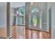 Spacious living room with light walls, hardwood floors, and a grand entrance with lots of natural light at 411 Baneberry Bnd, Peachtree City, GA 30269