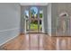 Bright living room with large arched windows and chandelier lighting, offering ample natural light and scenic views at 411 Baneberry Bnd, Peachtree City, GA 30269