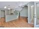Spacious living area with kitchen island, vaulted ceilings, and convenient access to the outdoors through a glass-paneled door at 411 Baneberry Bnd, Peachtree City, GA 30269