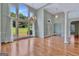 Bright living room featuring large windows, an elegant chandelier, and a welcoming entryway with decorative columns at 411 Baneberry Bnd, Peachtree City, GA 30269