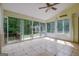 Bright sunroom with tile flooring, ceiling fan, large windows, and sliding glass doors at 411 Baneberry Bnd, Peachtree City, GA 30269