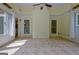 Well-lit sunroom featuring tile floors, a ceiling fan, and bright, airy windows at 411 Baneberry Bnd, Peachtree City, GA 30269