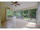 Light-filled sunroom featuring tile floors, a ceiling fan, and sliding doors to the deck at 411 Baneberry Bnd, Peachtree City, GA 30269