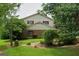 Charming two-story home with a mix of siding and brick, complemented by lush landscaping at 7369 Aubrey Dr, Riverdale, GA 30296