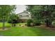Charming two-story home featuring a lush, green lawn and mature trees in a serene, residential setting at 7369 Aubrey Dr, Riverdale, GA 30296
