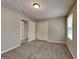 Bedroom featuring neutral walls, carpet, a window, double closets and white doors at 1311 Bustling Sw Ln, Marietta, GA 30064