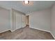 Bedroom features neutral paint, carpet, a window, and a double closet with white doors at 1311 Bustling Sw Ln, Marietta, GA 30064