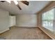 Bedroom with ceiling fan and plenty of natural light from the large window at 1311 Bustling Sw Ln, Marietta, GA 30064