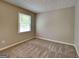 Bedroom with neutral walls, carpet, one window and an electrical outlet at 1311 Bustling Sw Ln, Marietta, GA 30064